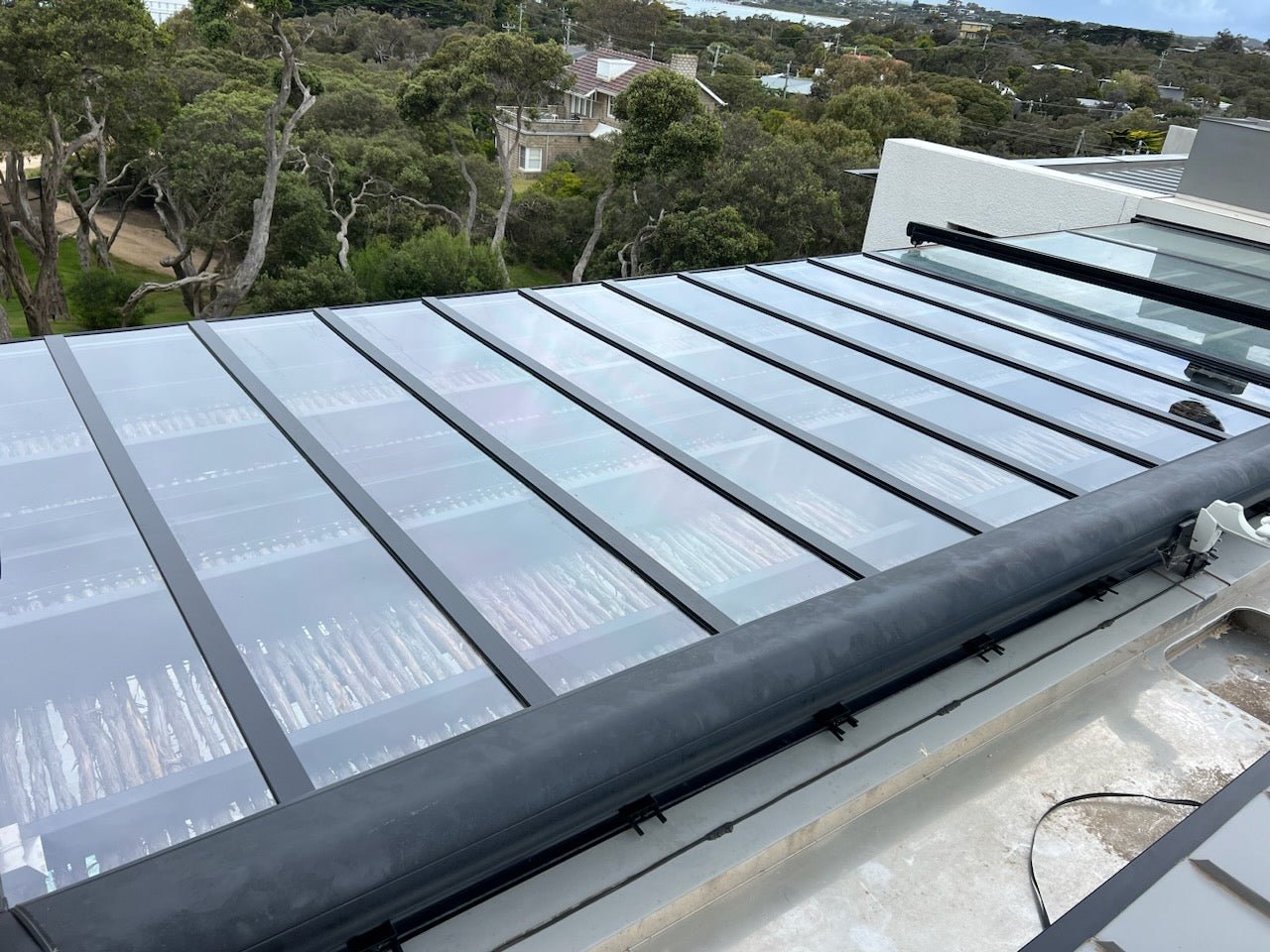 Clear polycarbonate pergola roof installed in Melbourne backyard – glass-like appearance with superior durability