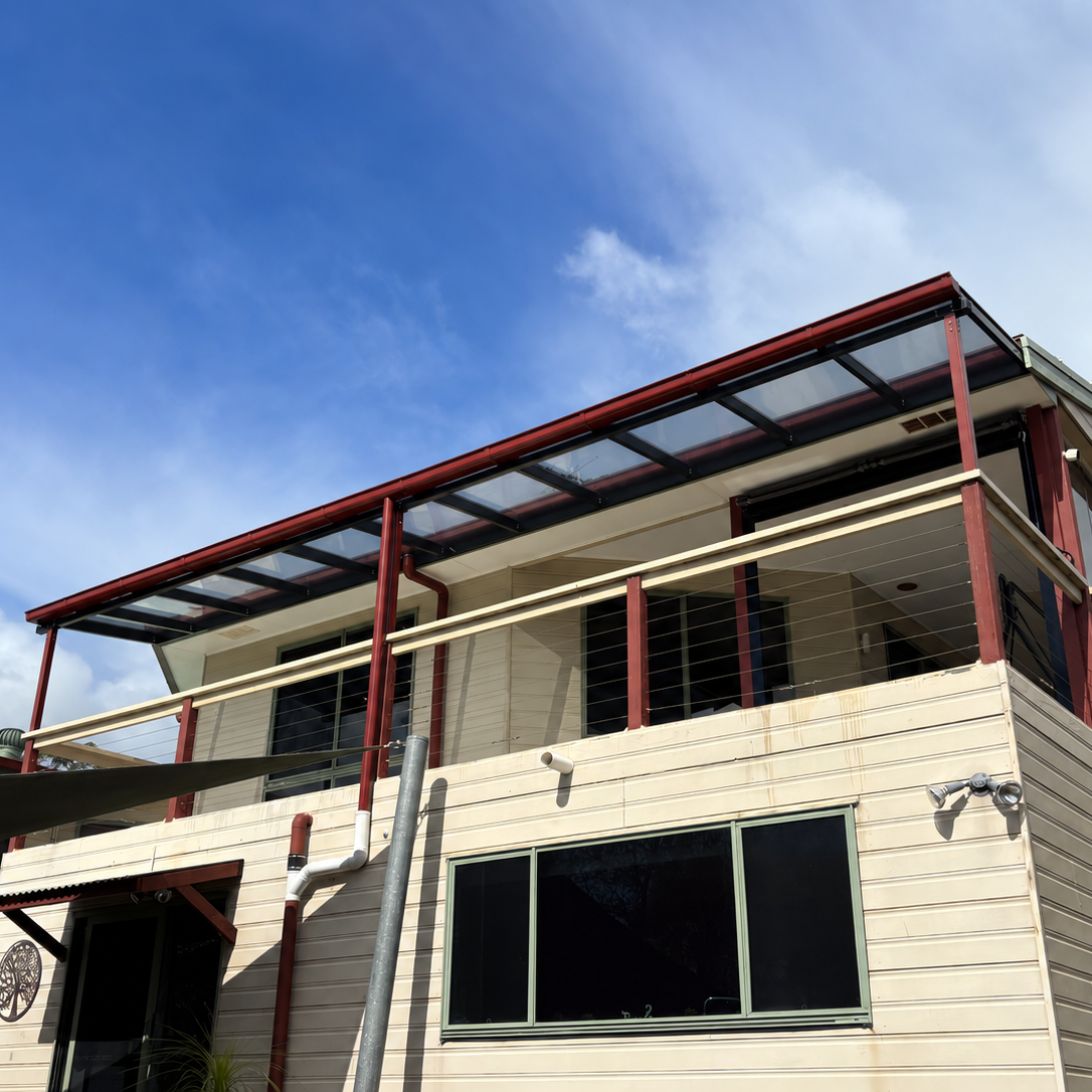 Balcony Pergola with Red posts tinted grey roofing 