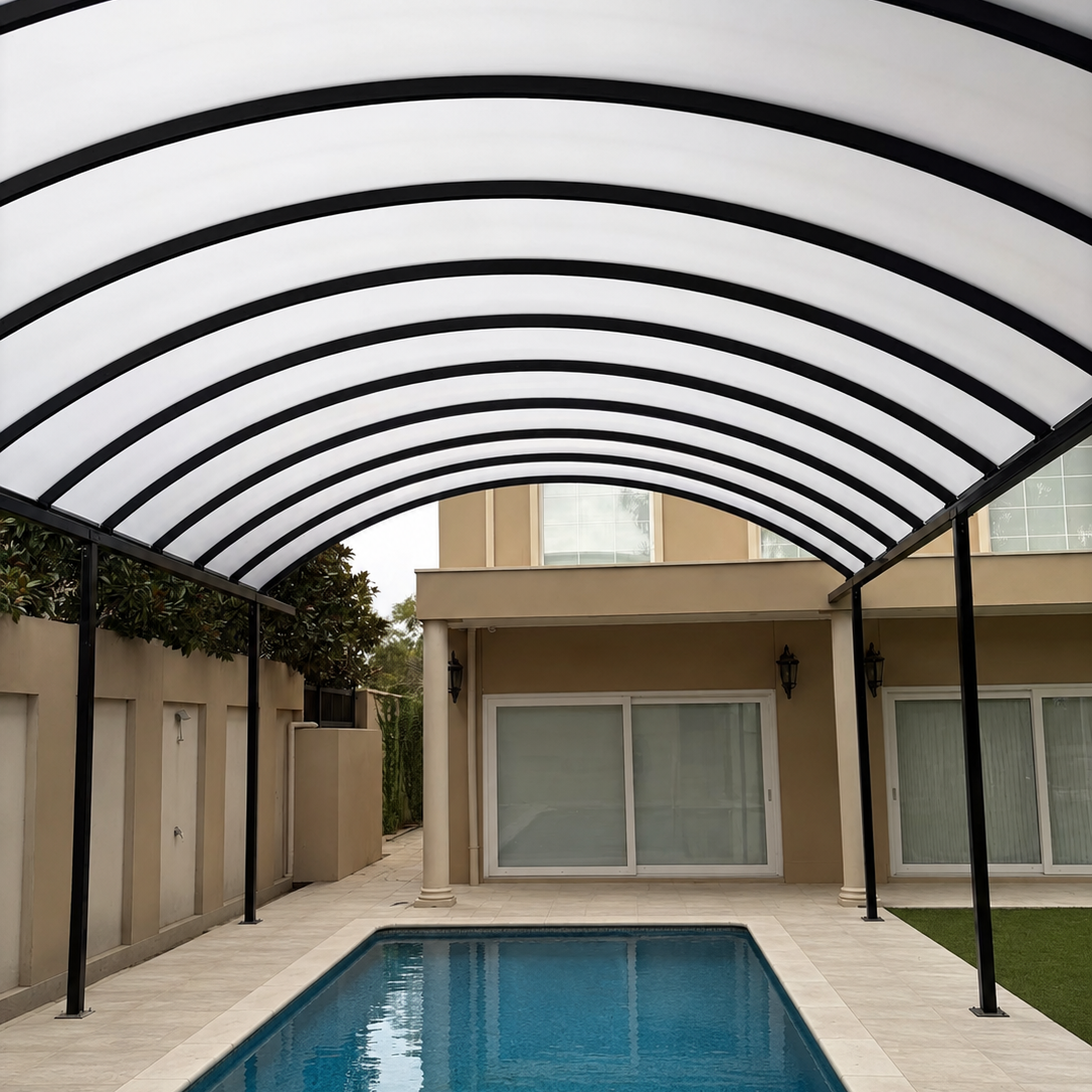 A modern curved roof canopy with a white translucent semi-glass panel top and black steel arches, covering a rectangular swimming pool in an outdoor residential backyard setting.